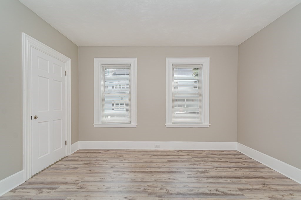 48 Washington Street Lawrence, MA 01841 - Photo 10 of 38 a view of an empty room with wooden floor and a window