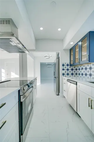 a kitchen with granite countertop a sink and a stove top oven