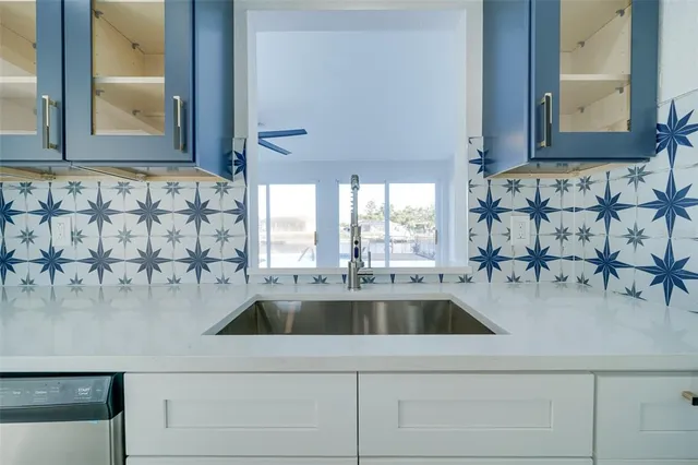 a view of a kitchen with white cabinets
