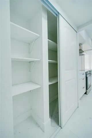 a view of a livingroom with a ceiling fan and window