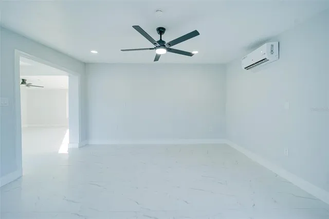 an empty room with closet and windows