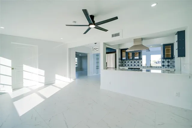 a view of a livingroom with furniture and a ceiling fan