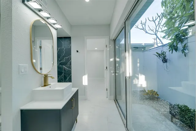 a bathroom with a toilet a sink and a mirror