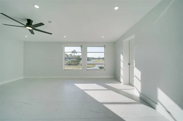 a kitchen with white cabinets and white stainless steel appliances