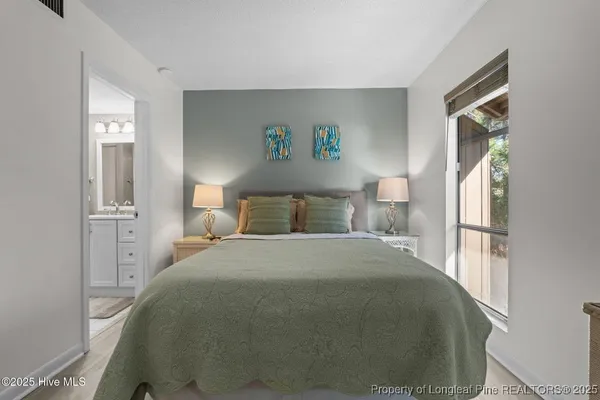 a bedroom with a bed and a window