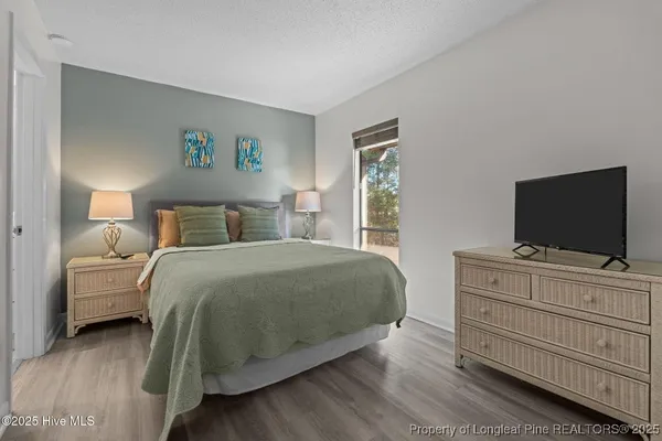 a bedroom with a bed and a flat screen tv