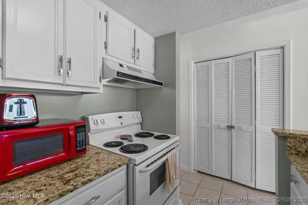 a kitchen with a stove and a refrigerator
