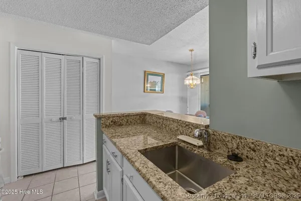 a utility room with faucet cabinets and a sink