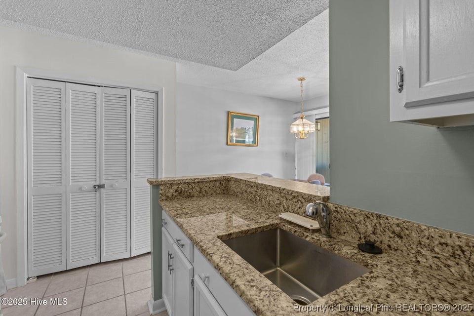 10 Pine Tree Road, Unit 211 Pinehurst, NC 28374 - Photo 18 of 36 a utility room with faucet cabinets and a sink