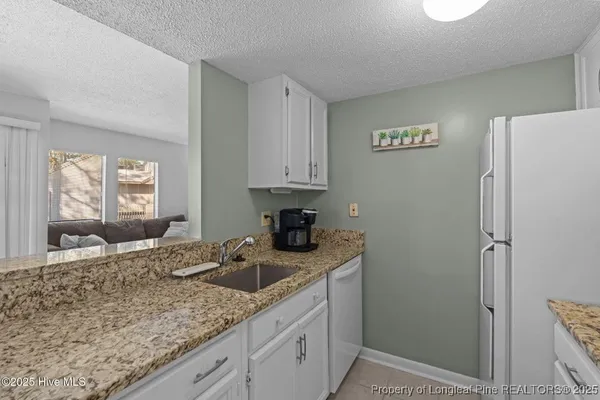 a kitchen with a sink cabinets and window