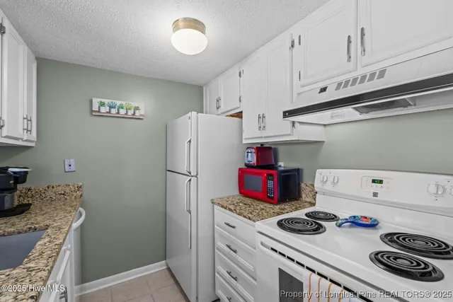 a kitchen with a stove and a refrigerator