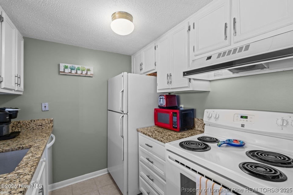 10 Pine Tree Road, Unit 211 Pinehurst, NC 28374 - Photo 20 of 36 a kitchen with a stove and a refrigerator