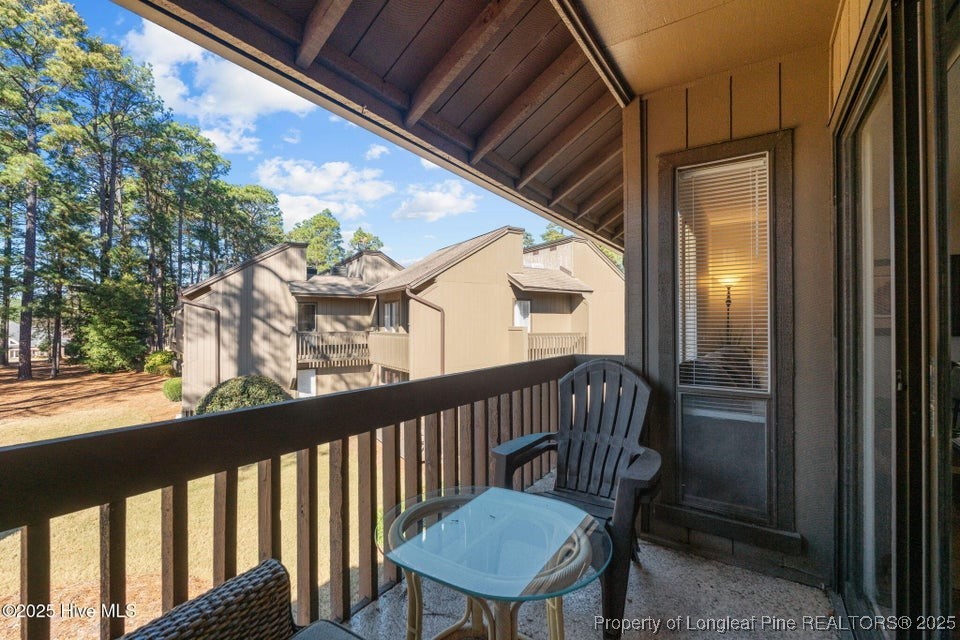 10 Pine Tree Road, Unit 211 Pinehurst, NC 28374 - Photo 23 of 36 a view of a balcony with a chair