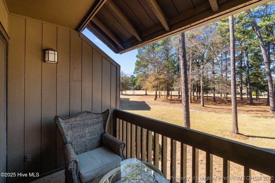 10 Pine Tree Road, Unit 211 Pinehurst, NC 28374 - Photo 24 of 36 a view of a porch with a table and chairs