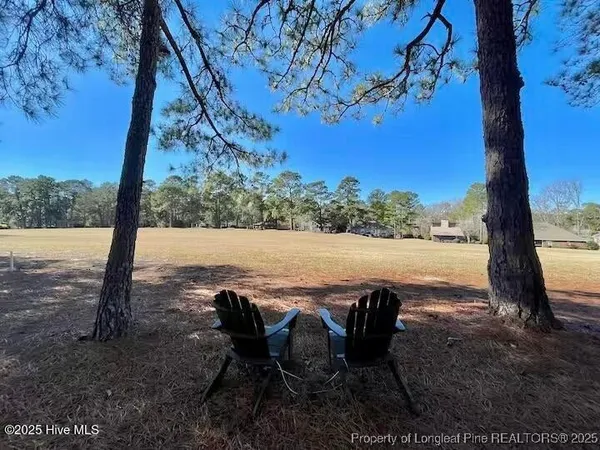 a view of lake with table and chairs
