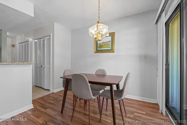 a view of a dining room with furniture wooden floor and a chandelier