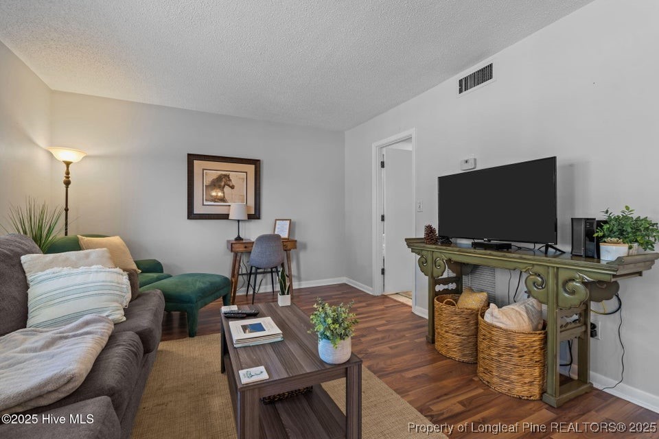 10 Pine Tree Road, Unit 211 Pinehurst, NC 28374 - Photo 9 of 36 a living room with furniture and a flat screen tv