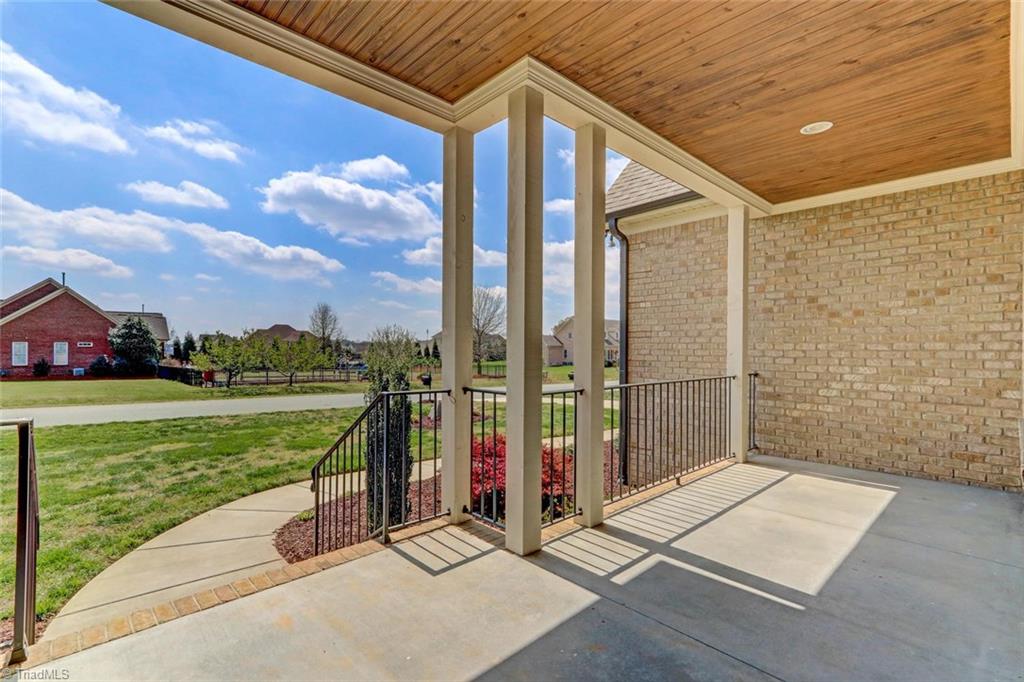 5410 Red Fox Drive Oak Ridge, NC 27310 - Photo 4 of 30 Enjoy your covered porch with Wood Ceiling Accent!