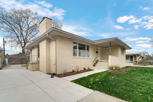 a backyard of a house with table and chairs