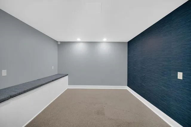 a side view of a house with backyard and barbeque grill