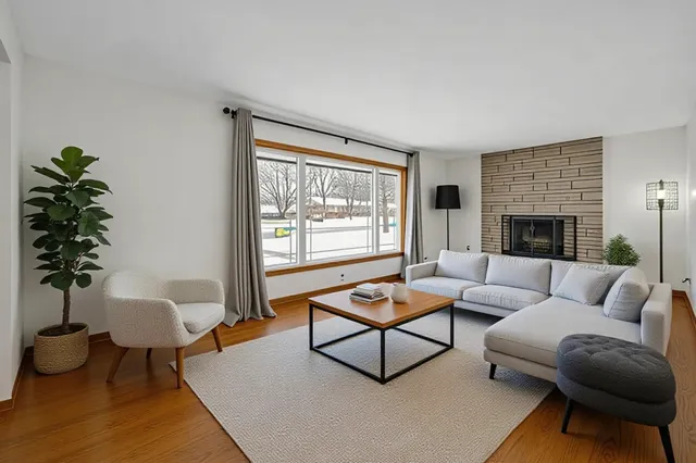 a living room with furniture and a potted plant