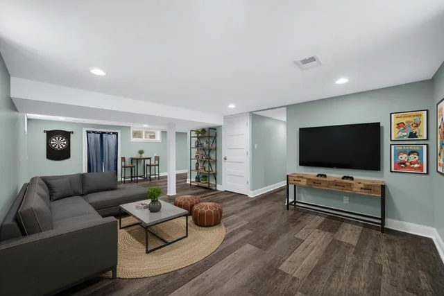 a living room with furniture and a flat screen tv