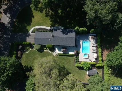 an aerial view of a house with a yard basket ball court and outdoor seating