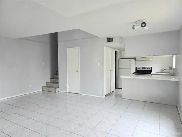 a view of kitchen with refrigerator and cabinets