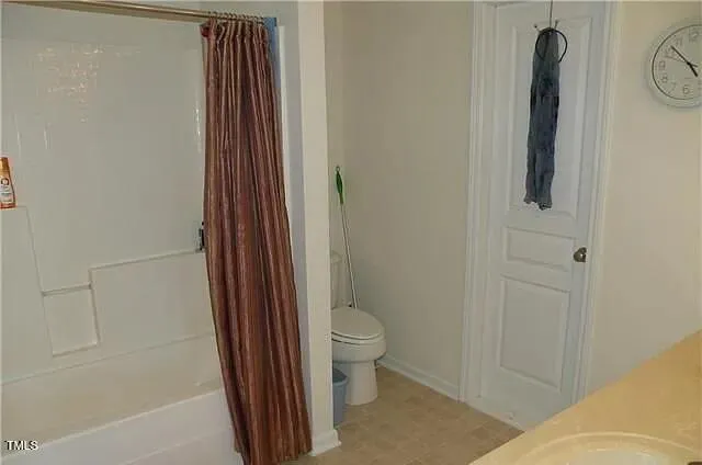 a bathroom with a shower and a toilet