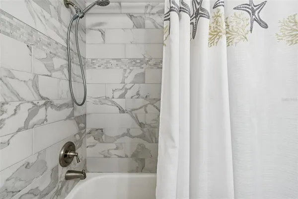 a bathroom with a bathtub and shower