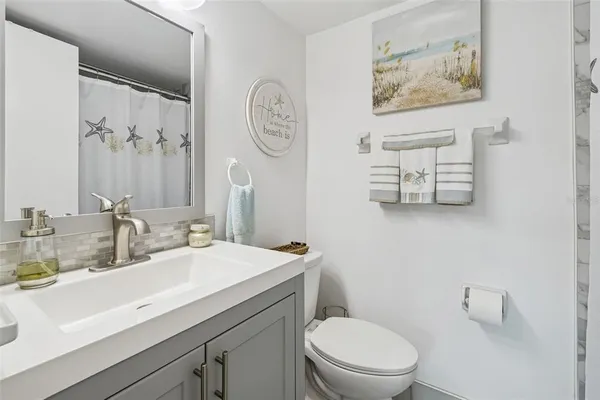 a bathroom with a toilet a sink and a mirror