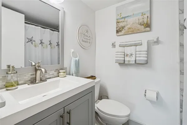 a bathroom with a toilet a sink and a mirror