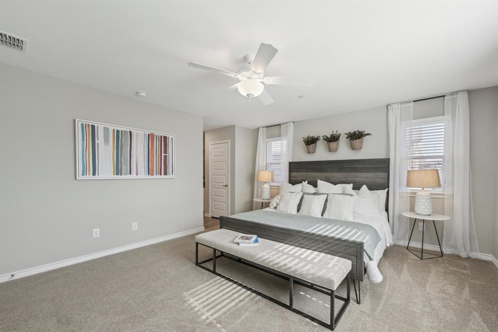 4430 Prairie Crossing, Unit 100 Prosper, TX 75078 - Photo 19 of 38 a bedroom with a bed and a ceiling fan