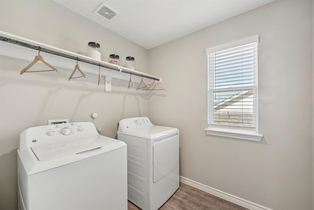 4430 Prairie Crossing, Unit 100 Prosper, TX 75078 - Photo 19 of 34 Clothes washing area featuring dark hardwood / wood-style flooring and separate washer and dryer
