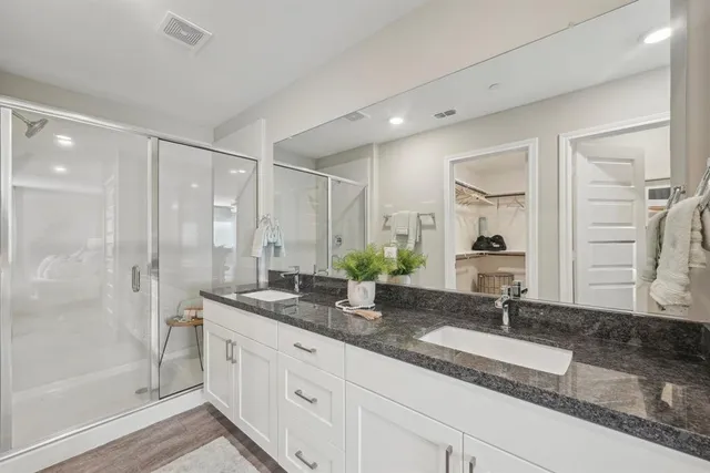 a bathroom with a granite countertop sink and a mirror
