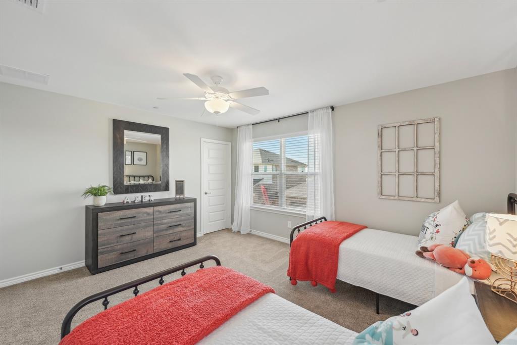 4430 Prairie Crossing, Unit 100 Prosper, TX 75078 - Photo 21 of 34 Carpeted bedroom with ceiling fan