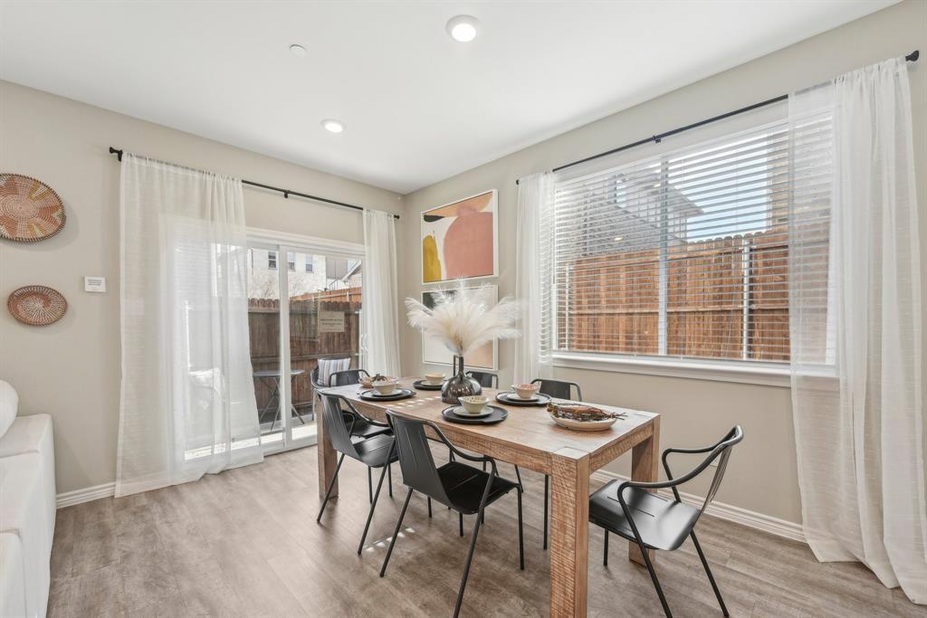 4430 Prairie Crossing, Unit 100 Prosper, TX 75078 - Photo 23 of 34 Dining area featuring plenty of natural light and light hardwood / wood-style floors