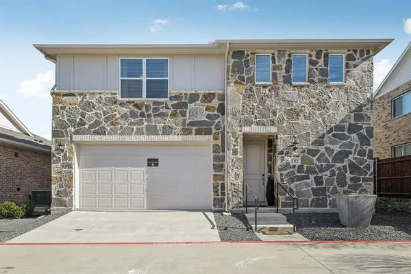 a front view of a house with garage