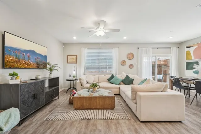 a living room with furniture and wooden floor