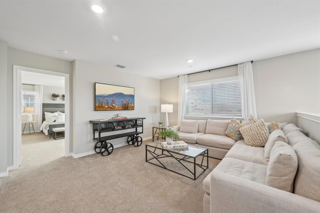 4430 Prairie Crossing, Unit 100 Prosper, TX 75078 - Photo 7 of 38 a living room with furniture and a large window