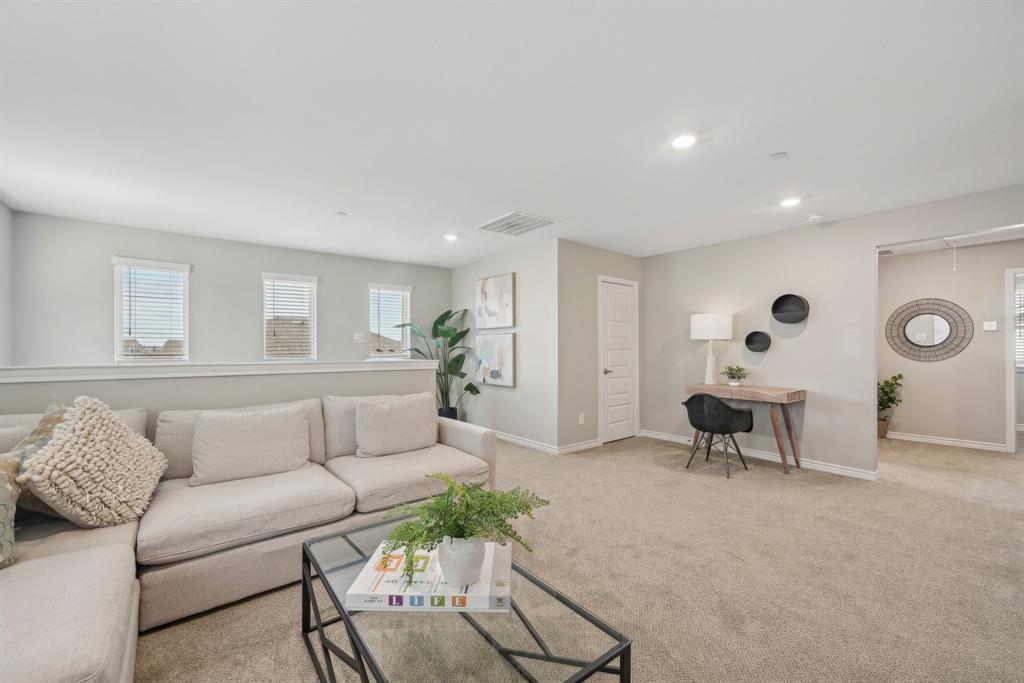 4430 Prairie Crossing, Unit 100 Prosper, TX 75078 - Photo 8 of 38 a living room with furniture and a couch