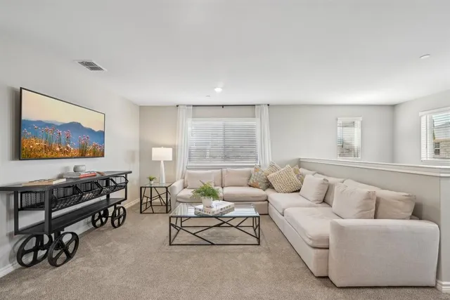 a kitchen with stainless steel appliances granite countertop a stove top oven a sink dishwasher and white cabinets with wooden floor