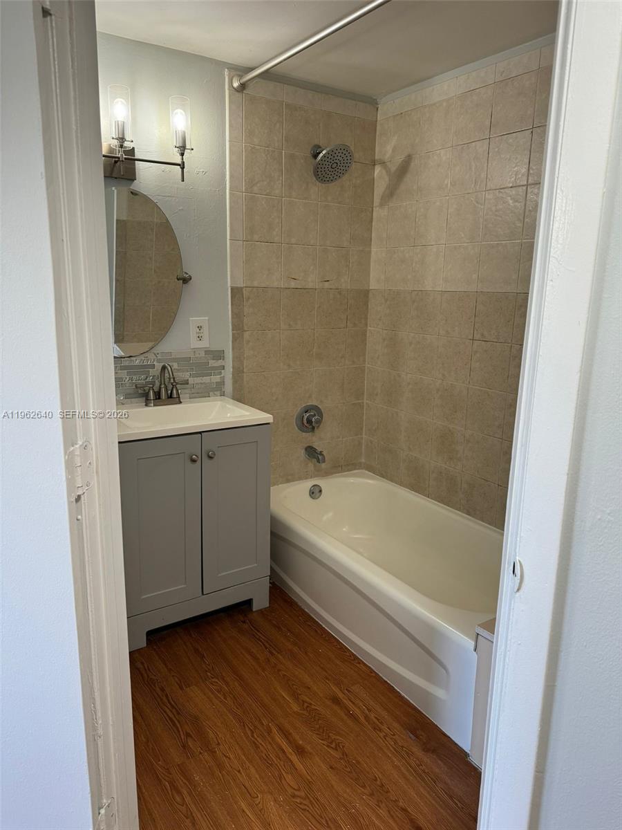 103 Northwest 6th Avenue, Unit 2 Miami, FL 33128 - Photo 12 of 20 a bathroom with a tub a sink and mirror