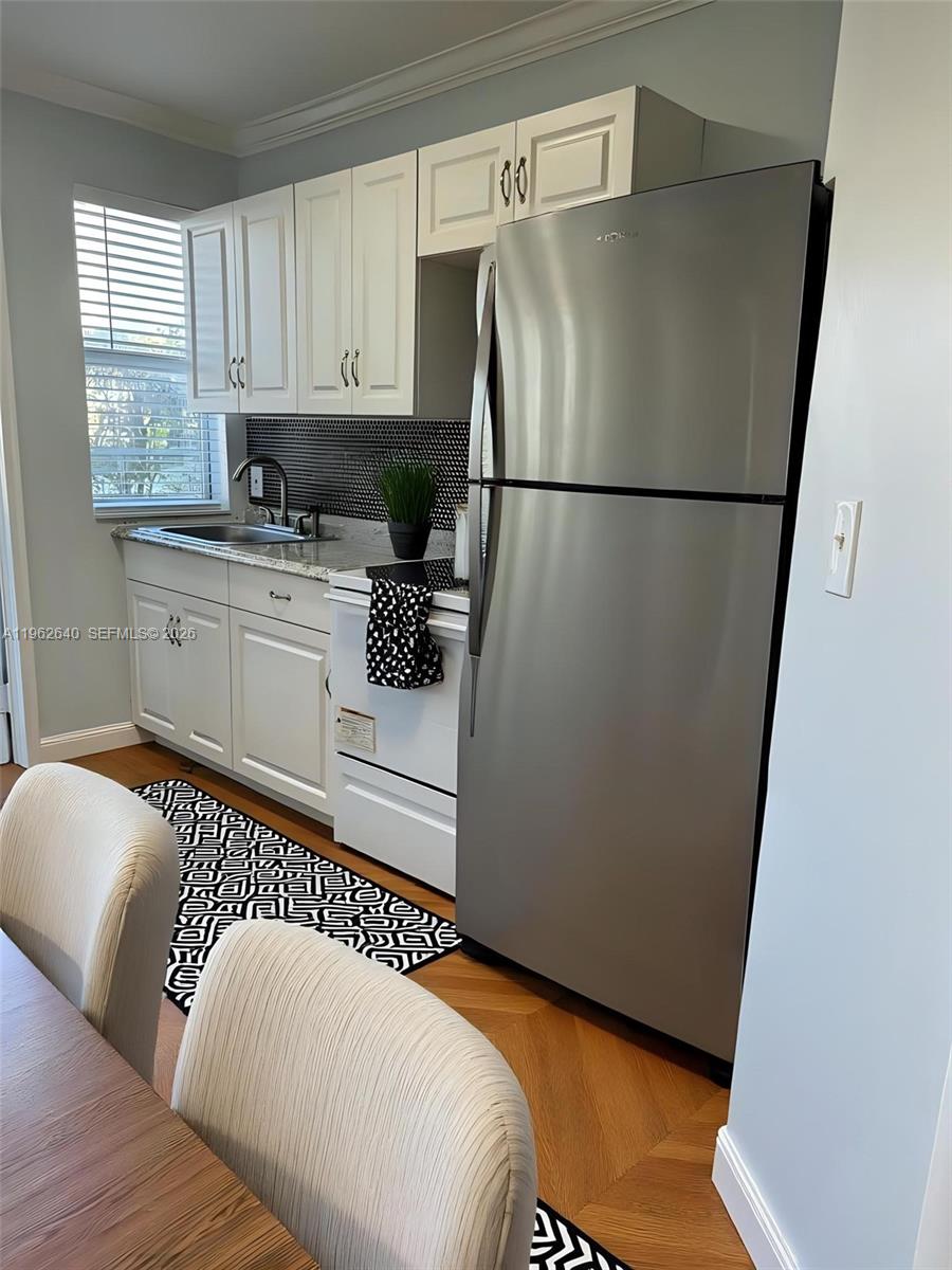 103 Northwest 6th Avenue, Unit 2 Miami, FL 33128 - Photo 4 of 20 a bedroom with a bed a window a couch and cabinets