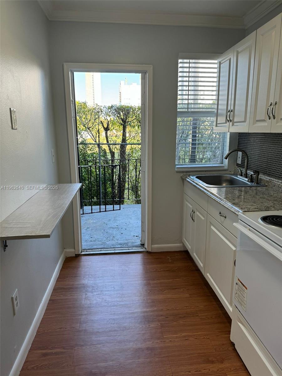 103 Northwest 6th Avenue, Unit 2 Miami, FL 33128 - Photo 5 of 20 a kitchen with a sink a window and cabinets