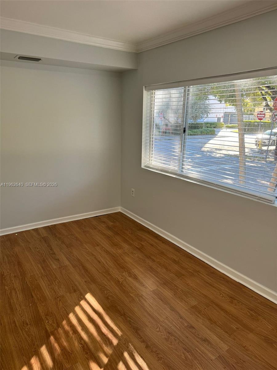 103 Northwest 6th Avenue, Unit 2 Miami, FL 33128 - Photo 7 of 20 a view of empty room with wooden floor and fan
