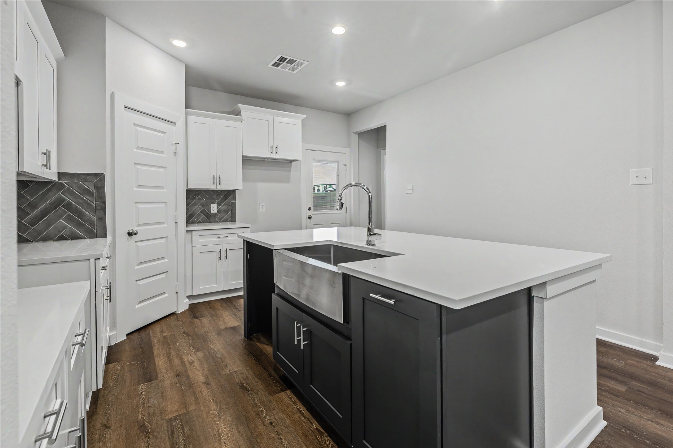 6423 Bolinas Court Rosharon, TX 77583 - Photo 10 of 39 a kitchen with a sink cabinets and wooden floor