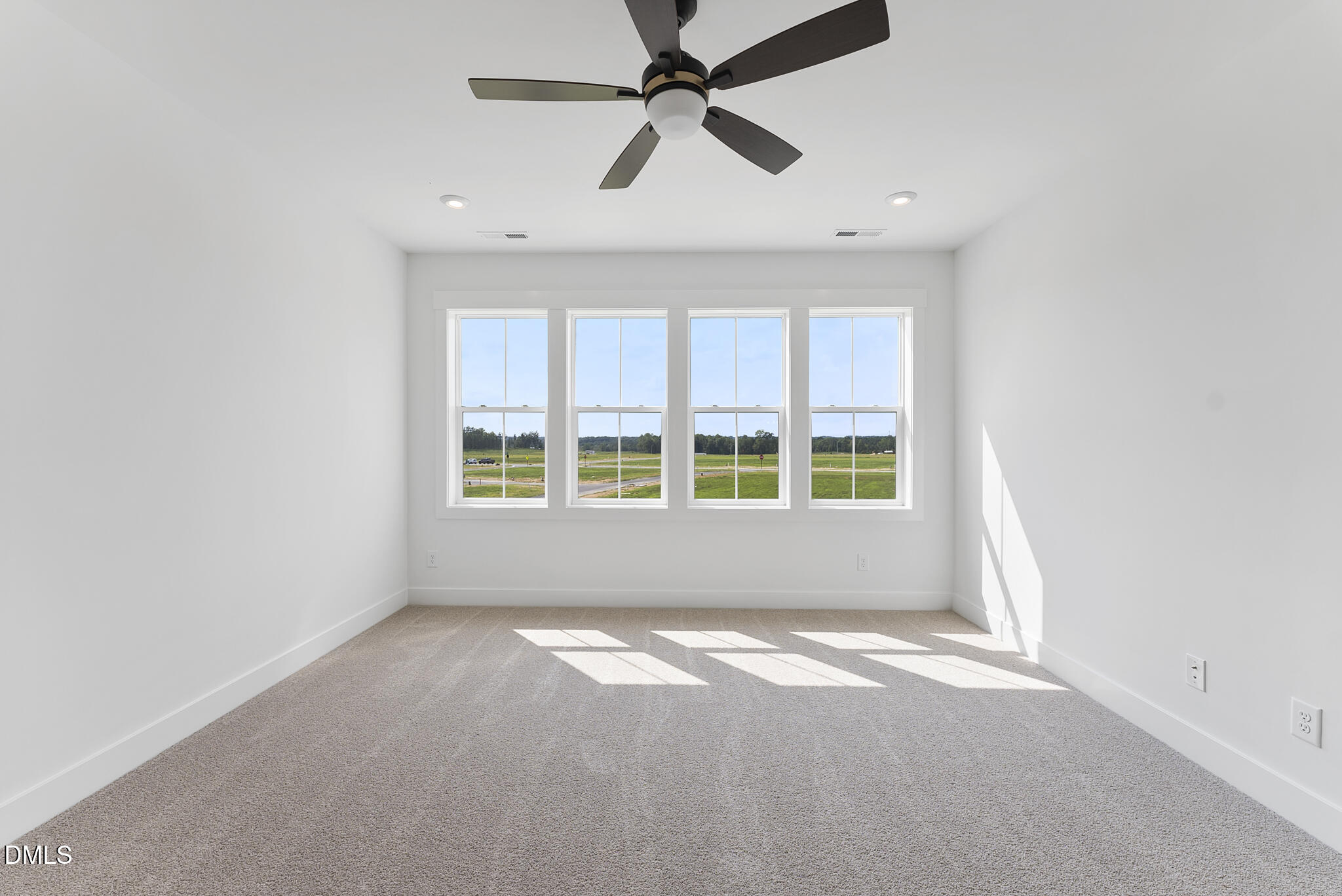 761 West Holly Springs Road Holly Springs, NC 27540 - Photo 43 of 61 an empty room with a window and a ceiling fan