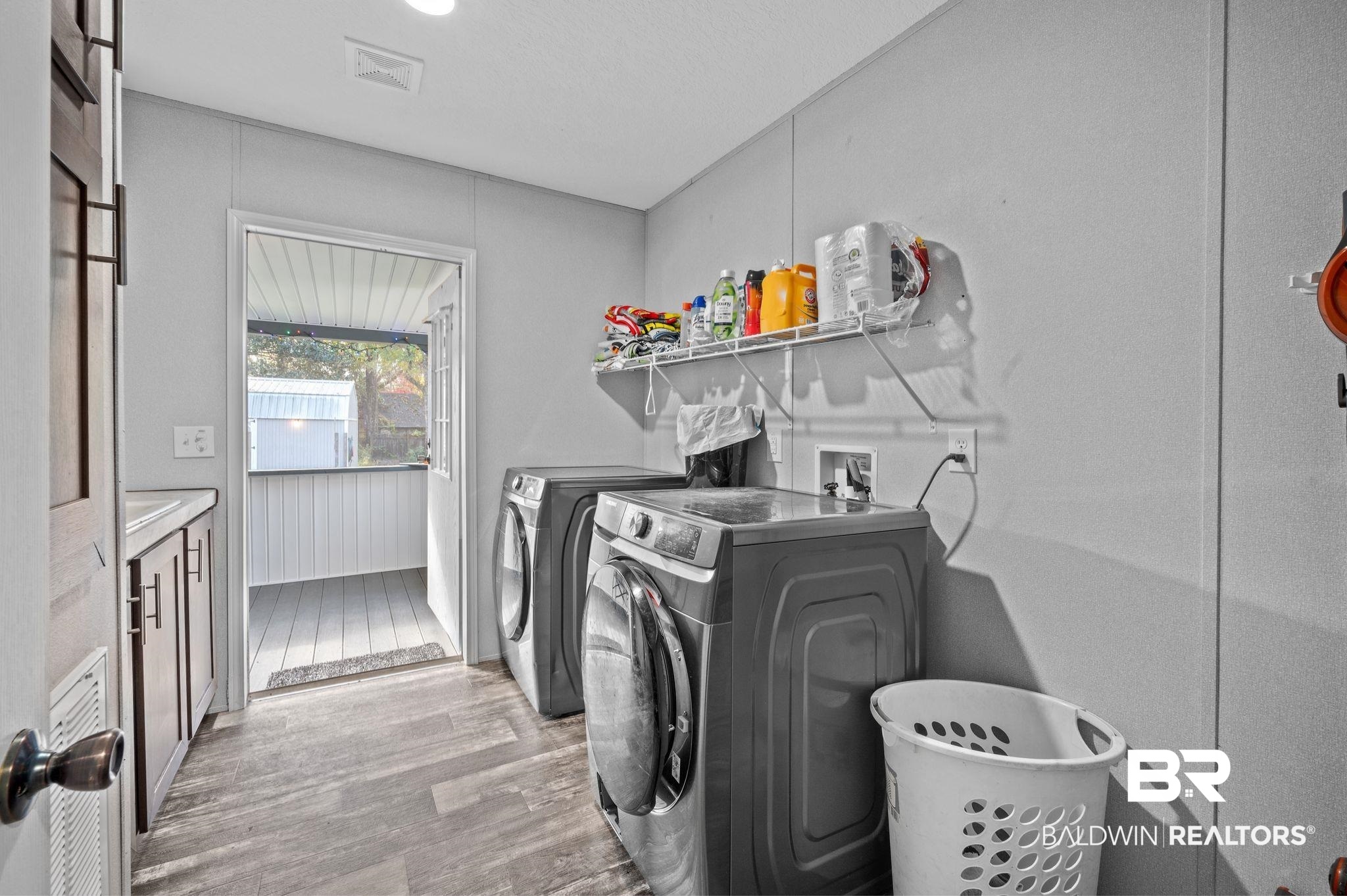 9382 D'Olive Street Bay Minette, AL 36507 - Photo 15 of 27 Laundry room featuring independent washer and dryer and light hardwood / wood-style floors