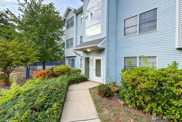 a view of a house with potted plants